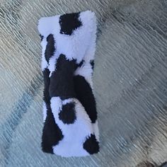 a black and white cow rug laying on the ground