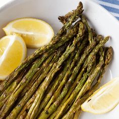 asparagus and lemons on a white plate