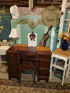 an antique desk and chair in a room with hats on the headboard, wallpapered walls and flooring