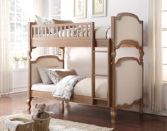 a wooden bunk bed sitting on top of a hard wood floor next to a window