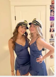 two beautiful young women dressed in blue posing for the camera