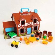 there is a toy house with toys in front of it