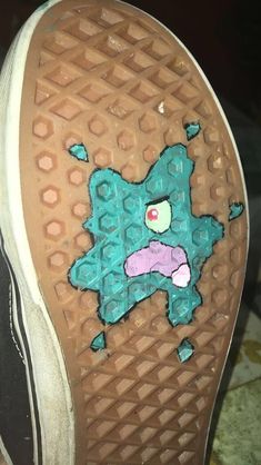 someone's shoes with an image of a cartoon character painted on the soles