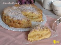 a cake sitting on top of a white plate next to a fork and cup filled with liquid