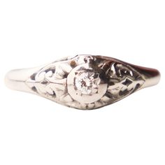 an antique silver ring with a diamond in the center