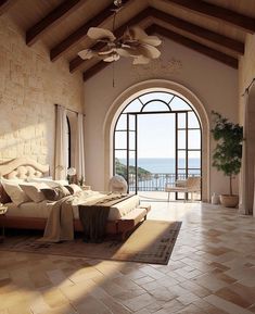 a bedroom with an arched ceiling and large windows