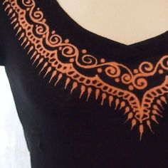 a black top with an orange design on it