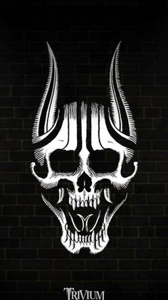 a skull with horns and fangs on it's head in front of a brick wall