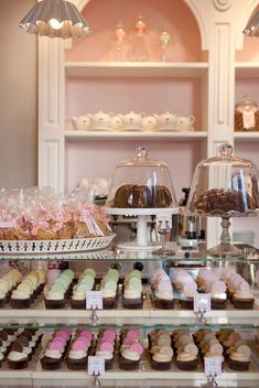 a display case filled with lots of different types of cupcakes and pastries