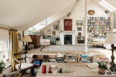 a living room filled with furniture and a fire place in the middle of a room