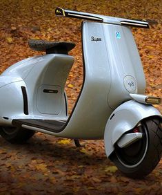 an electric scooter is parked on the ground in front of some autumn leaves