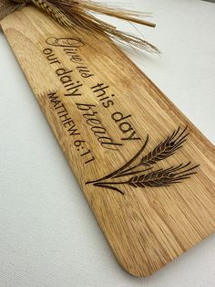 a wooden cutting board with wheat on it that says, no one has made this bread together