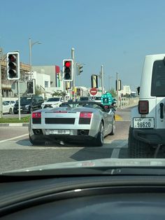 two cars stopped at a red light in the city