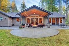 a large house with a covered patio in the front yard