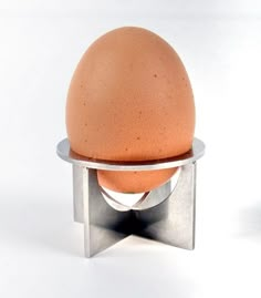 an egg sitting on top of a metal stand