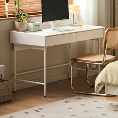 a white desk with a computer on top of it