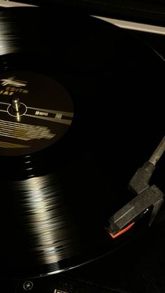 an old record player with its turntable turned upside down on a table in the dark