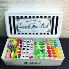 a lunch box filled with lots of different colored candies