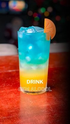 a blue and yellow drink sitting on top of a table