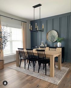 a dining room table surrounded by black chairs