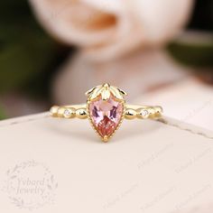 "(Please confirm your US size when you make an order) Jewelry Details -Gold Type:  Solid 14K Gold / Solid 18K Gold (Choose One in Material Option) Center Stone: Natural Pink Morganite 5*7mm, Approximately 0.80ct Cut: Pear Cut Side Stone: 0.028cttw diamond Color: G-H Clarity: SI1 Cut: Round Cut / 3EX Band Width: approximately 1.3mm SKU: YR1022 ~*-*~Purchase Guarantee: - All our jewelry is handmade, and each process is refined. - 14 Day Refund Guarantee. - All our products are Free Shipping. - Free Gift Box&Packing. ~*-*~Please contact us if you need service: 1. Ring Resizing. 2. Metal Change(PT950/10k/14k/18k White/Yellow/Rose Gold). 3. Engraving ring (less than 10 letter). 4. Accept customization. We believe that our quality, attention to detail, design and customer service make us stand o Strawberry Wedding Ring, Strawberry Engagement Ring, Pink Diamond Gold Ring, Pink 14k Gold Pear-shaped Jewelry, Pink Pear-shaped 14k Gold Jewelry, Strawberry Ring, Art Deco Rings, Deco Rings, Womp Womp