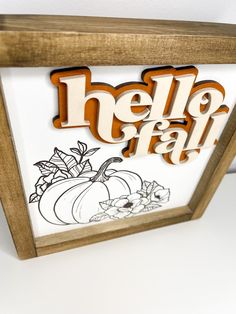 a wooden frame with the word hello fall painted on it