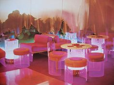 a room filled with lots of purple and orange furniture