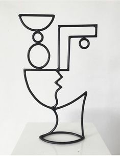 a metal sculpture on top of a white table