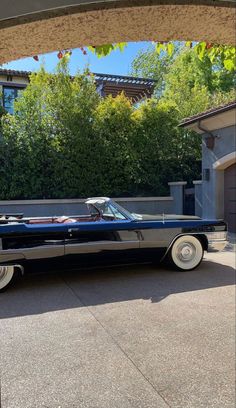 an old car parked in front of a house