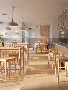 an empty restaurant with wooden tables and stools