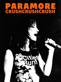 a woman singing into a microphone with the words paramore crushcrush on it