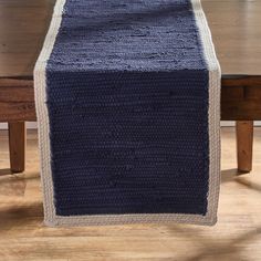 a blue table runner on top of a wooden table