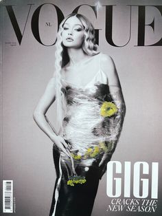 a magazine cover with a woman in black and white dress on the front, wearing yellow flowers