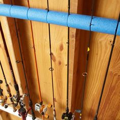 there are many fishing rods hanging on the wall