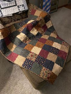 a patchwork chair with a quilt on it