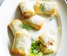 some food is on a white plate with green garnish and sprouts