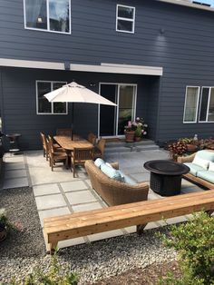 an outdoor patio area with seating and umbrella