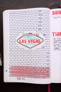 an open notebook with the las vegas sign on it and writing in red, white, and blue