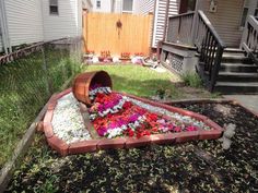 a flower bed in the middle of a yard