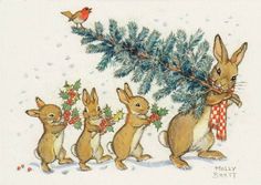 a group of rabbits standing next to each other in front of a christmas tree with berries on it