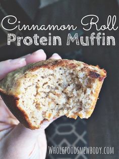 a person holding a piece of bread in their hand with the words cinnamon roll protein muffin