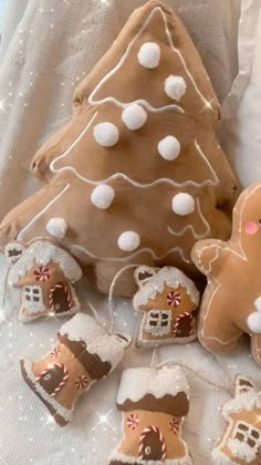 gingerbread christmas cookies and decorations on a white tablecloth with sequined fabric