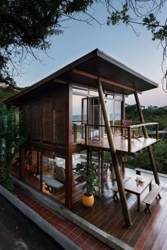 a small wooden house sitting on top of a wooden deck