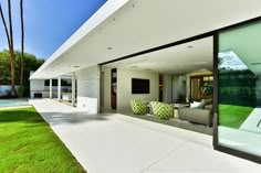 a modern house with large glass windows overlooking the pool