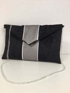 Black and gray iridescent evening clutch bag, wedding clutch bag envelope shape customizable, small handbag with flap and removable chain for a shoulder or shoulder strap, very trendy for your outings, a wedding, bridesmaids or a ceremony. This elegant pouch will easily contain your essential phone, makeup, keys, glasses, papers ... The pouch is made of thick suedette, very velvety touch, suede effect, with a strip of iridescent gray vegetable leatherette hemmed with a silver border. 2 options a Silver Chic Clutch For Gift, Silver Chic Clutch As A Gift, Chic Silver Clutch For Gift, Modern Silver Clutch For Evening, Elegant Gray Pouch Bag, Modern Silver Clutch For Party, Elegant Magnetic Closure Envelope Evening Bag, Chic Silver Clutch Evening Bag, Elegant Envelope Evening Bag With Removable Pouch