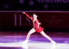 a female figure skating on an ice rink