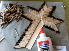 matches and glue are used to make a wooden cross