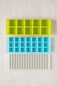 three ice trays sitting next to each other on top of a white countertop