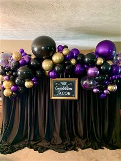 a table with balloons and a chalkboard on it