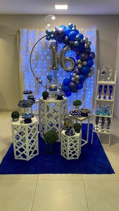 blue and silver balloons are on display in front of a large balloon arch with the number ten